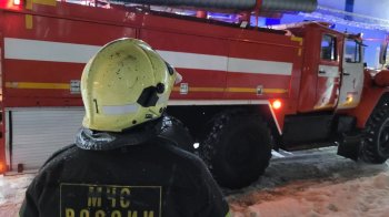 Огнеборец на фоне пожарной машины.